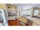 Bright kitchen features granite counters, stainless appliances, white cabinetry, and wood floors at 4506 Gentrice Dr, Valrico, FL 33596