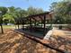Outdoor pavilion with multiple picnic tables and trash receptacles at 4506 Gentrice Dr, Valrico, FL 33596
