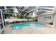 Enclosed pool with a brick trim and a variety of plant life in the background at 4506 Gentrice Dr, Valrico, FL 33596