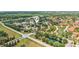 Community aerial view features well-maintained homes, mature trees, scenic lakes, and convenient street access at 6621 La Mesa Rd, Land O Lakes, FL 34637