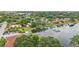 Beautiful aerial view of a lakeside community, showcasing homes with orange roofs surrounded by mature trees at 6621 La Mesa Rd, Land O Lakes, FL 34637