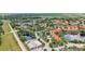 Community aerial view features well-maintained homes, mature trees, scenic lakes, and convenient street access at 6621 La Mesa Rd, Land O Lakes, FL 34637