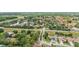 Community aerial view features well-maintained homes, mature trees, scenic lakes, and convenient street access at 6621 La Mesa Rd, Land O Lakes, FL 34637