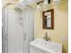 Bathroom featuring a sink vanity, mirror, and stand-up shower with glass door at 6621 La Mesa Rd, Land O Lakes, FL 34637