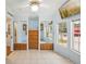 Bedroom with tile floors, mounted TV, built in drawers and mirrored closets at 6621 La Mesa Rd, Land O Lakes, FL 34637