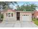 Charming home featuring a spacious driveway, attached garage, and front entryway at 6621 La Mesa Rd, Land O Lakes, FL 34637