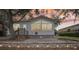Charming home with a red roof, large windows and a brick patio is surrounded by mature trees at 6621 La Mesa Rd, Land O Lakes, FL 34637