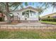Charming home with a red roof, large windows and a brick patio is surrounded by mature trees at 6621 La Mesa Rd, Land O Lakes, FL 34637
