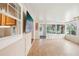 Large Florida room with a built in wet bar, natural light, and tiled floor at 6621 La Mesa Rd, Land O Lakes, FL 34637