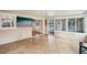 Bright Florida room with tile flooring and multiple windows offering serene backyard and lake views at 6621 La Mesa Rd, Land O Lakes, FL 34637