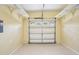 Bright, empty garage with a white door and access to power outlets at 6621 La Mesa Rd, Land O Lakes, FL 34637