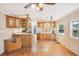 Bright open-concept kitchen featuring wood cabinets, stainless appliances, and countertop dining at 6621 La Mesa Rd, Land O Lakes, FL 34637