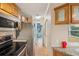 Galley kitchen featuring stainless appliances, wooden cabinets and hardwood floors at 6621 La Mesa Rd, Land O Lakes, FL 34637