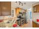 Renovated kitchen featuring granite countertops, wood cabinets, and stainless steel appliances at 6621 La Mesa Rd, Land O Lakes, FL 34637