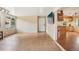 Open-concept living room featuring a bright space and entryway to the kitchen at 6621 La Mesa Rd, Land O Lakes, FL 34637