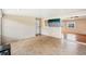 Bright living room with neutral paint, tile flooring, and abundant natural light at 6621 La Mesa Rd, Land O Lakes, FL 34637
