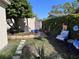Landscaped backyard with mature trees, lush plants, and stone pathway at 836 41St N Ave, St Petersburg, FL 33703