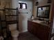 Bathroom featuring dark wood cabinets, granite counters, and framed mirror at 836 41St N Ave, St Petersburg, FL 33703