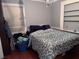 Bedroom features hardwood floors, large bed, closet and is well lit by a window and chandelier at 836 41St N Ave, St Petersburg, FL 33703