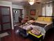 Spacious bedroom with hardwood floors, en-suite bathroom, and door to the outside at 836 41St N Ave, St Petersburg, FL 33703
