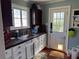 Cozy kitchen features white cabinetry, granite countertops, stainless steel sink, and a window over looking the outdoors at 836 41St N Ave, St Petersburg, FL 33703