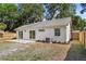Spacious backyard with a patio area, lawn, and partial fence at 1103 Hardwood Dr, Valrico, FL 33596