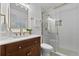 Stylish bathroom featuring a glass-enclosed shower, modern vanity, and patterned tile flooring at 1103 Hardwood Dr, Valrico, FL 33596