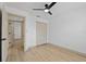 Neutral bedroom features a ceiling fan and closet with bi-fold doors at 1103 Hardwood Dr, Valrico, FL 33596