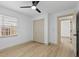 Bright bedroom with light wood floors, a ceiling fan, and a closet with folding doors at 1103 Hardwood Dr, Valrico, FL 33596