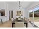 Bright dining area features a contemporary light fixture and sliding glass door to the backyard at 1103 Hardwood Dr, Valrico, FL 33596