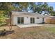 Back exterior view of home with sliding glass doors to the backyard patio and green space at 1103 Hardwood Dr, Valrico, FL 33596