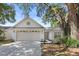 Charming single-story home with a well-maintained lawn, mature landscaping, and a two-car garage at 1103 Hardwood Dr, Valrico, FL 33596