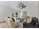 Bright living room with neutral decor, modern ceiling fan, and sliding glass door to the backyard at 1103 Hardwood Dr, Valrico, FL 33596