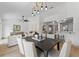 Open-concept living and dining area with stylish light fixture and plenty of natural light at 1103 Hardwood Dr, Valrico, FL 33596