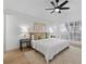 Inviting main bedroom with a ceiling fan, plush bedding, and light-filled windows at 1103 Hardwood Dr, Valrico, FL 33596