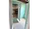 Unfinished basement with shelving, open doorway, and aqua blue painted wall at 21077 Gertrude Ave, Port Charlotte, FL 33952