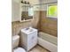 Standard bathroom features a shower-tub combo, large vanity, and window at 21077 Gertrude Ave, Port Charlotte, FL 33952