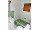 Bathroom with a green tub and tiled walls, complemented by a coordinating vanity and fixtures at 21077 Gertrude Ave, Port Charlotte, FL 33952