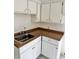 Kitchen area featuring white cabinets, brown countertops, and stainless steel sink at 21077 Gertrude Ave, Port Charlotte, FL 33952