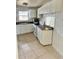 Functional kitchen with white cabinetry, essential appliances, and tile flooring for easy maintenance at 21077 Gertrude Ave, Port Charlotte, FL 33952
