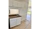 Traditional kitchen with white cabinets, brown countertops, and tile flooring at 21077 Gertrude Ave, Port Charlotte, FL 33952