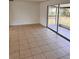 Living room featuring tile flooring and a sliding door at 21077 Gertrude Ave, Port Charlotte, FL 33952