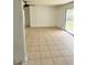 Spacious living room features tile flooring and access to a screened-in porch at 21077 Gertrude Ave, Port Charlotte, FL 33952