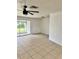 Living room with tile flooring, ceiling fan, and view to the outdoors at 21077 Gertrude Ave, Port Charlotte, FL 33952