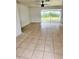 Bright living room featuring tile flooring and sliding glass doors at 21077 Gertrude Ave, Port Charlotte, FL 33952
