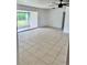 Living room featuring tile floors, neutral walls, and sliding doors at 21077 Gertrude Ave, Port Charlotte, FL 33952