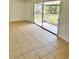 Living room with tile flooring leading to a screened-in patio, providing a relaxing transition at 21077 Gertrude Ave, Port Charlotte, FL 33952