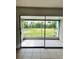Screened patio with tile flooring overlooking a spacious lawn and backyard at 21077 Gertrude Ave, Port Charlotte, FL 33952