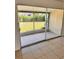 Enclosed patio with screened windows, offering a view of the green backyard and outdoor serenity at 21077 Gertrude Ave, Port Charlotte, FL 33952