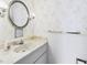 Charming bathroom features a vanity with a marble countertop, vintage wallpaper and sconces at 2700 Bayshore Blvd # 3210, Dunedin, FL 34698